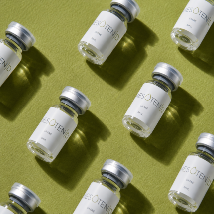Multiple Mesoten D DMAE 5ml vials arranged on a textured green background