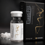 Close-up of ElastiFill vial with AKRADEX black packaging and white pellets in the background