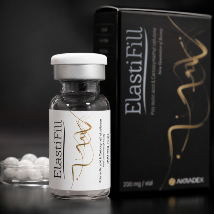 Close-up of ElastiFill vial with AKRADEX black packaging and white pellets in the background
