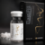 Close-up of ElastiFill vial with AKRADEX black packaging and white pellets in the background