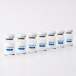 Lennea Booster 3ml vials lined up in a minimal white studio setting